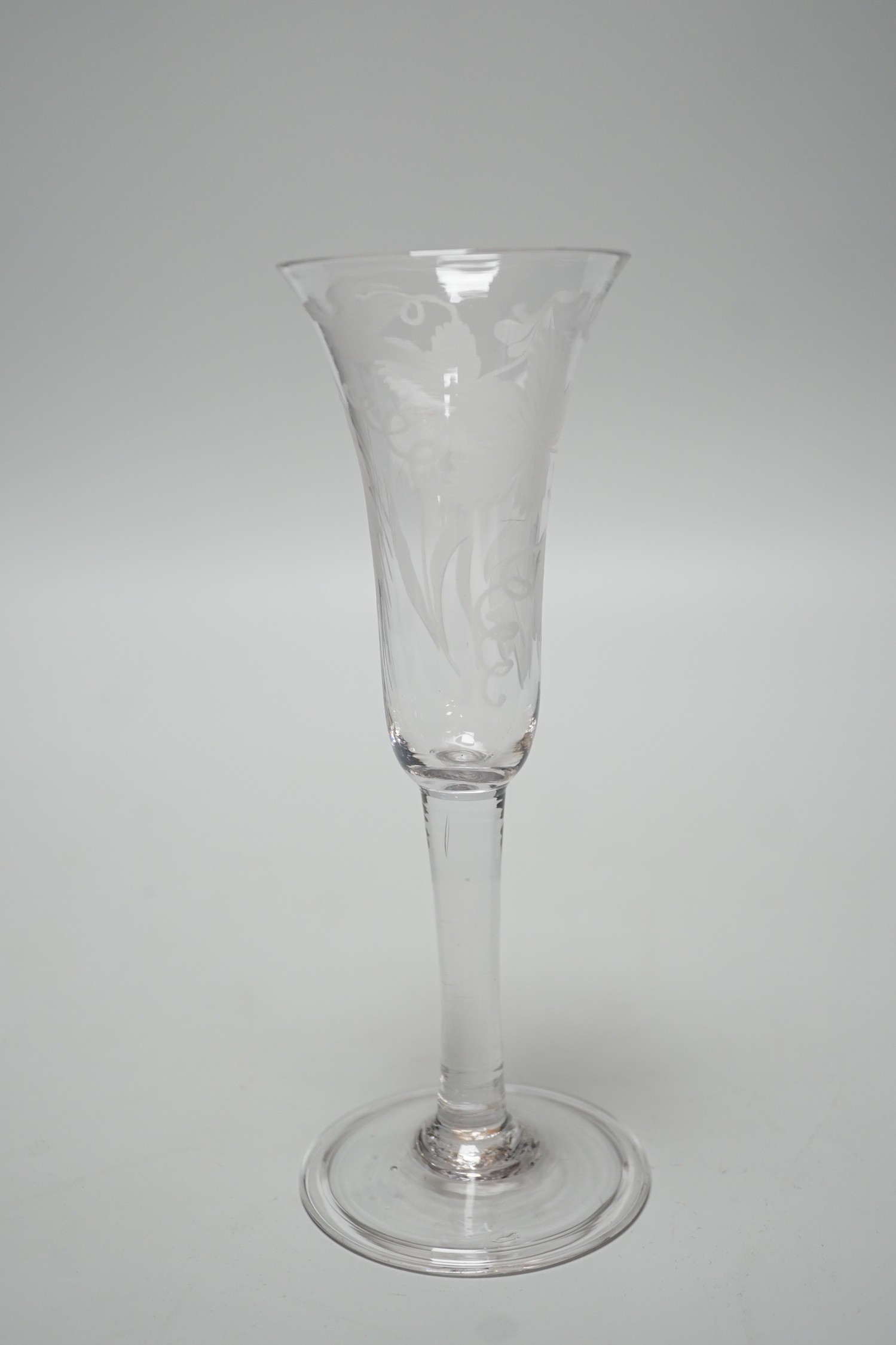 An 18th century engraved ale flute, folded foot, 19.5cms high